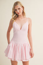 Mini dress with fitted bodice, thin straps, and gathered skirt