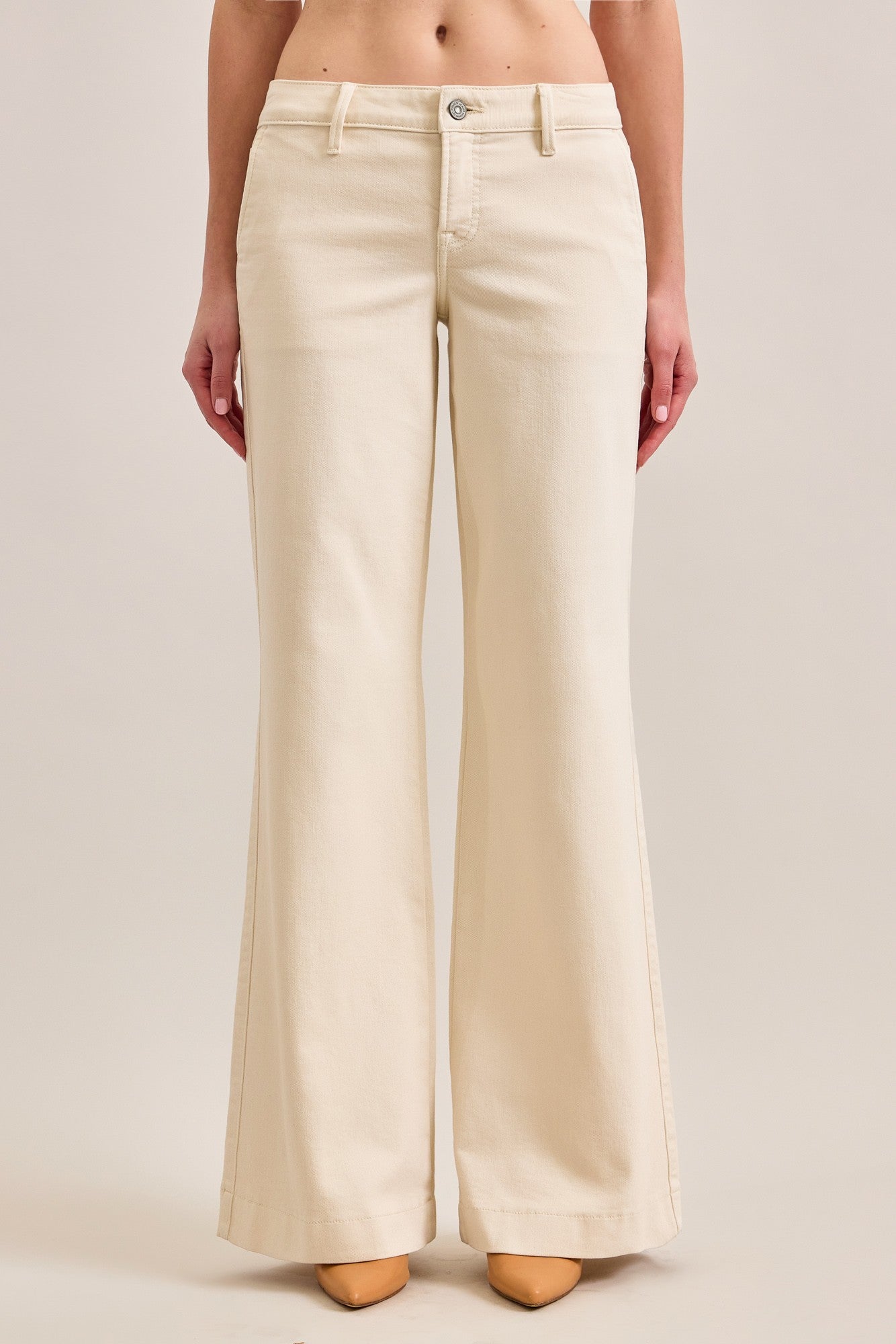 Mid-rise pants with tailored fit through the hips and subtle flare leg styled with heels