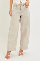 Model wearing high-rise wide-leg jeans with a relaxed fit and full-length silhouette.