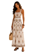 Model wearing a floral print tiered maxi dress with a square neckline, wide straps, and a fitted bodice.