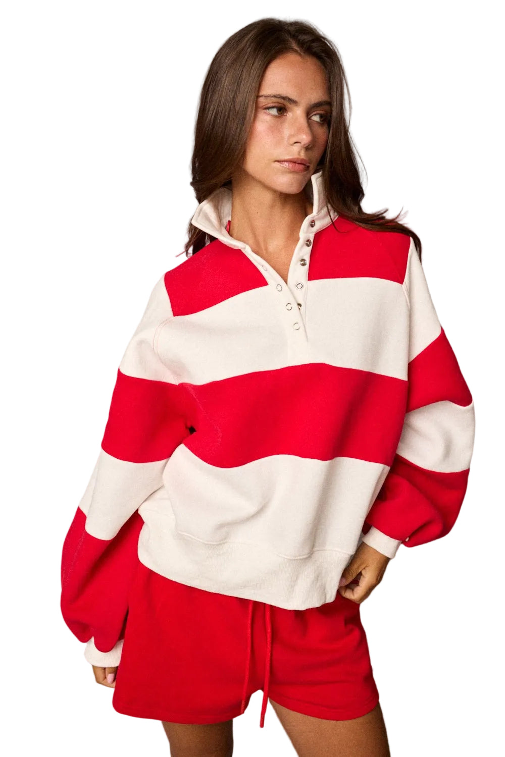 Model wearing a striped half-snap pullover sweatshirt with an oversized fit and matching drawstring shorts.