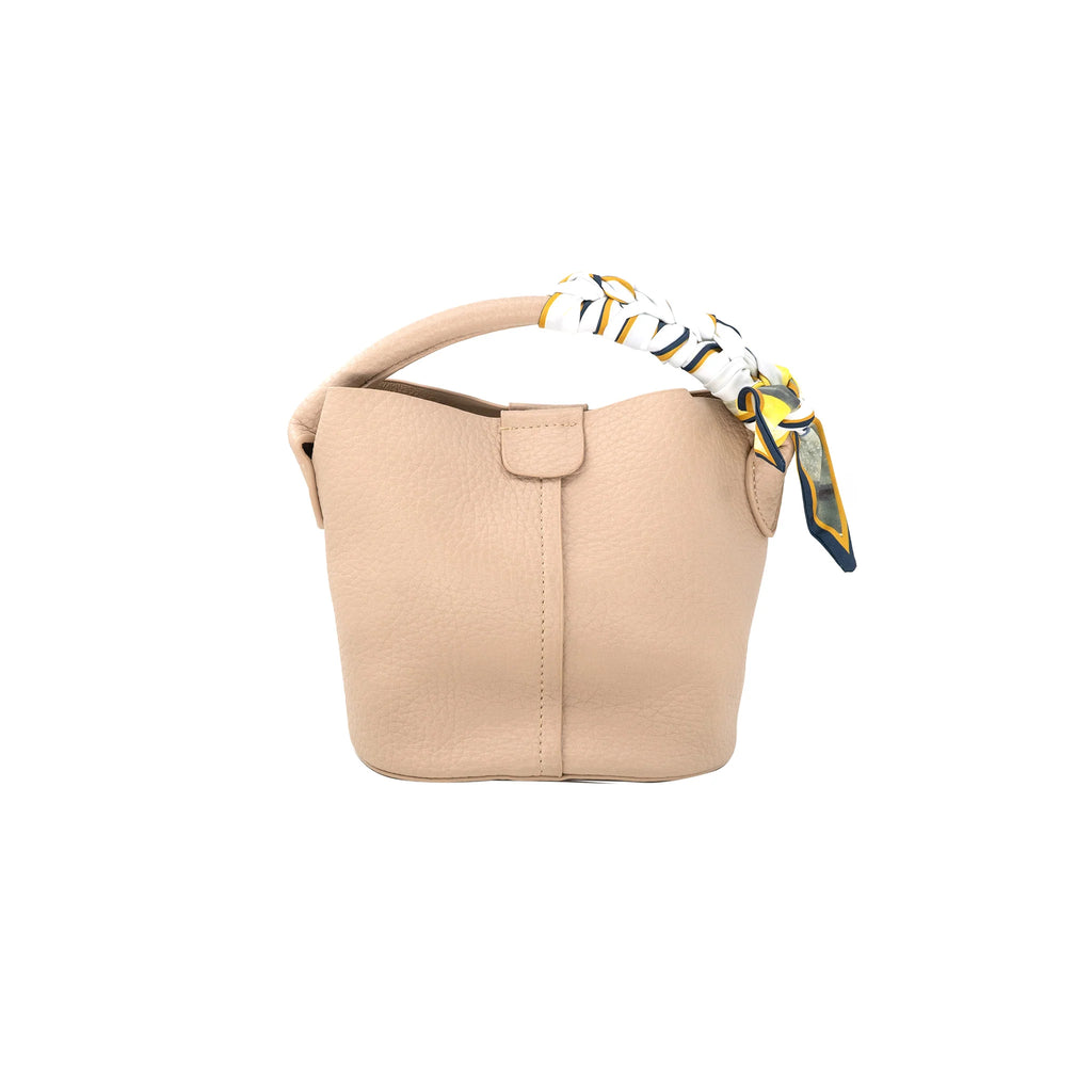 Scarf Tie Handbag Beige. This adorable handbag features a bucket design with a scarf detail on the top handle and a snap closure, the perfect pop of color to add to any outfit.