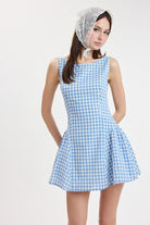 Gingham mini dress with fitted bodice and flared skirt styled with a headscarf