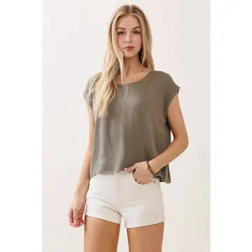 Model wearing a relaxed cap sleeve top with a lightweight draped silhouette.