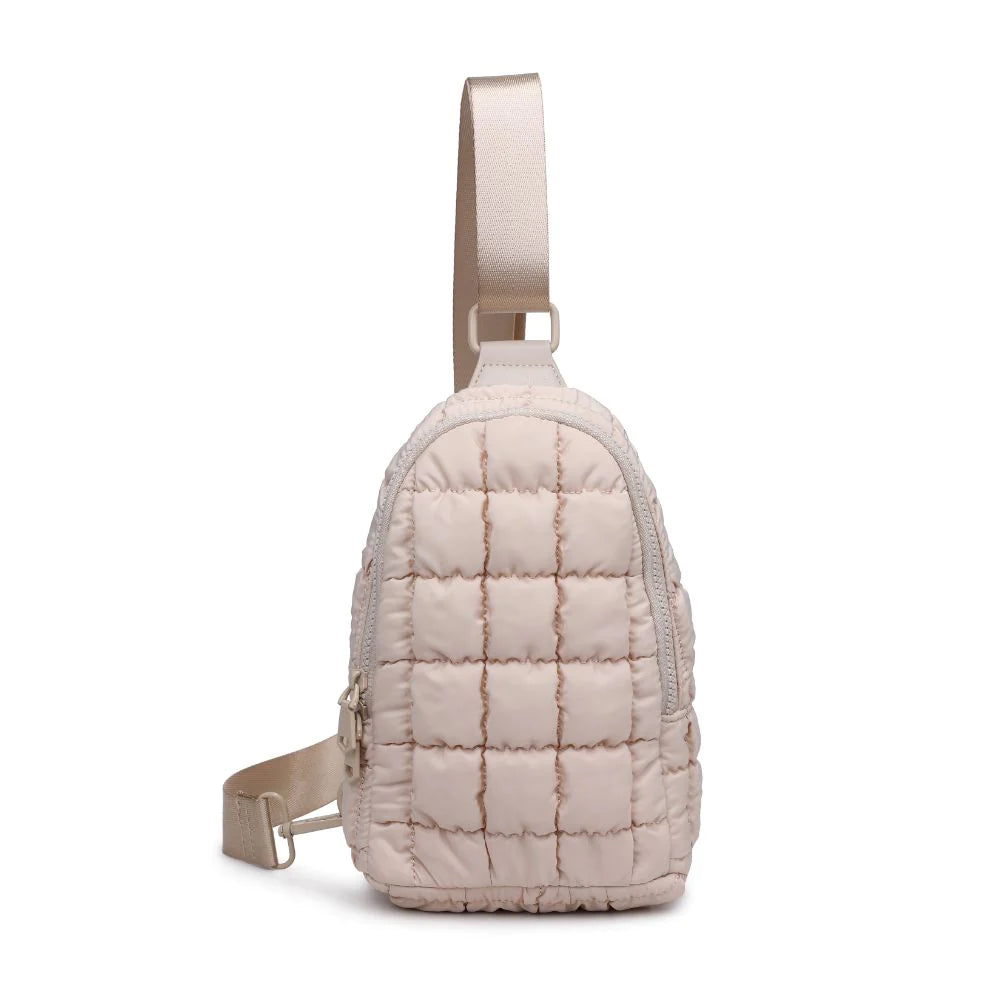 Sol and Selene Rejuvenate Sling Backpack Cream. The fashion-forward companion that fits right into your athleisure aesthetic. This nifty nylon number, showcasing a quilted design, packs style, and functionality into one neat, zippered package. So, you carry the essentials hands-free while looking effortlessly cool.