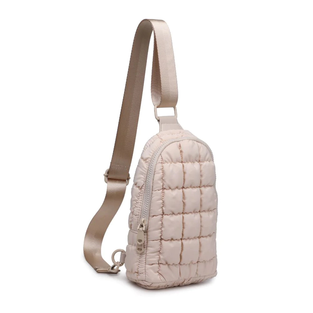 Sol and Selene Rejuvenate Sling Backpack Cream. The fashion-forward companion that fits right into your athleisure aesthetic. This nifty nylon number, showcasing a quilted design, packs style, and functionality into one neat, zippered package. So, you carry the essentials hands-free while looking effortlessly cool.