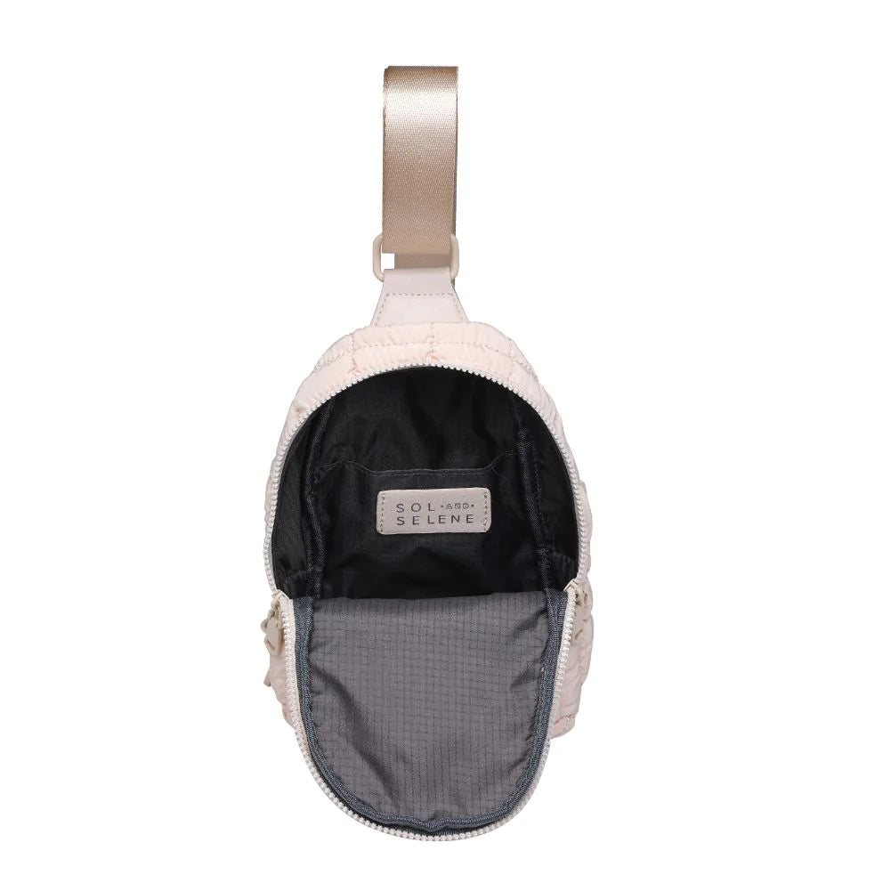 Sol and Selene Rejuvenate Sling Backpack Cream. The fashion-forward companion that fits right into your athleisure aesthetic. This nifty nylon number, showcasing a quilted design, packs style, and functionality into one neat, zippered package. So, you carry the essentials hands-free while looking effortlessly cool.