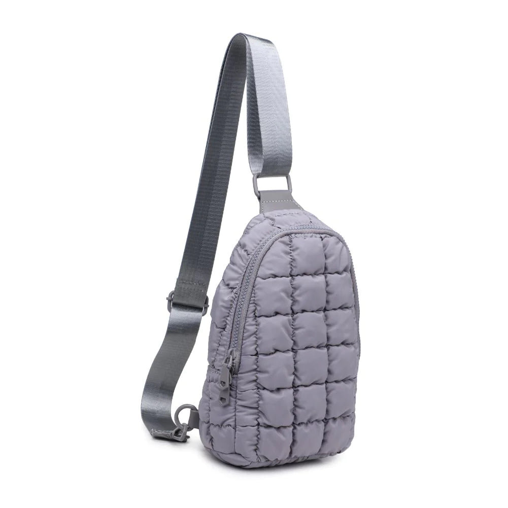 Sol and Selene Rejuvenate Sling Backpack Grey. The fashion-forward companion that fits right into your athleisure aesthetic. This nifty nylon number, showcasing a quilted design, packs style, and functionality into one neat, zippered package. So, you carry the essentials hands-free while looking effortlessly cool.
