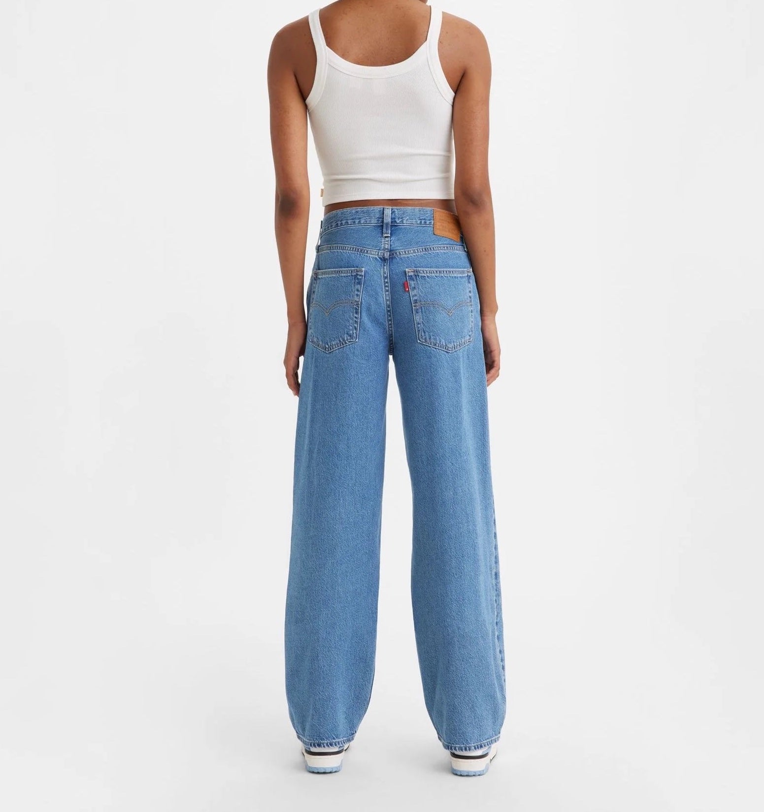 Levi Baggy Dad Jean Medium Blue Wash. The kind of jean you might steal from your dad's closet but baggier. With a mid rise and straight leg, this pair is relaxed yet flattering with extra room for a subtle edge.