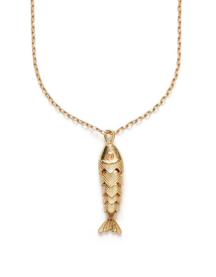 Delicate chain necklace featuring a textured fish pendant with a small stone detail.