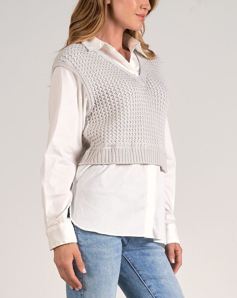 Elan Sweater Shirt Combo Top Heather Grey White. This sweater-shirt combo features a button-up long sleeve under with a knit cropped vest over. This in-office, or out-of-office look effortlessly blends sophistication with a trendy touch, making it a stylish and versatile choice for various occasions.