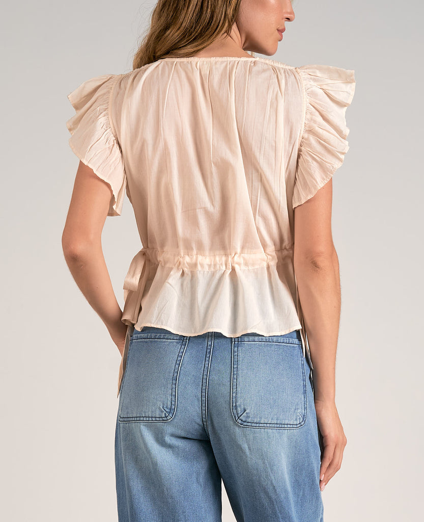 Elan Ruffle Sleeve V-Neck Top Beige. This pretty top features a v-neck design with ruffle sleeves and side tie details, perfect for day or night, it goes effortlessly with any jeans or pants.