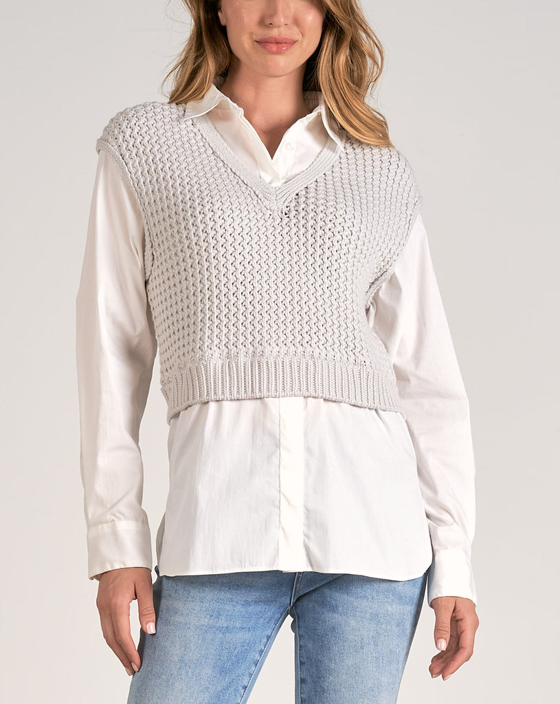 Elan Sweater Shirt Combo Top Heather Grey White. This sweater-shirt combo features a button-up long sleeve under with a knit cropped vest over. This in-office, or out-of-office look effortlessly blends sophistication with a trendy touch, making it a stylish and versatile choice for various occasions.