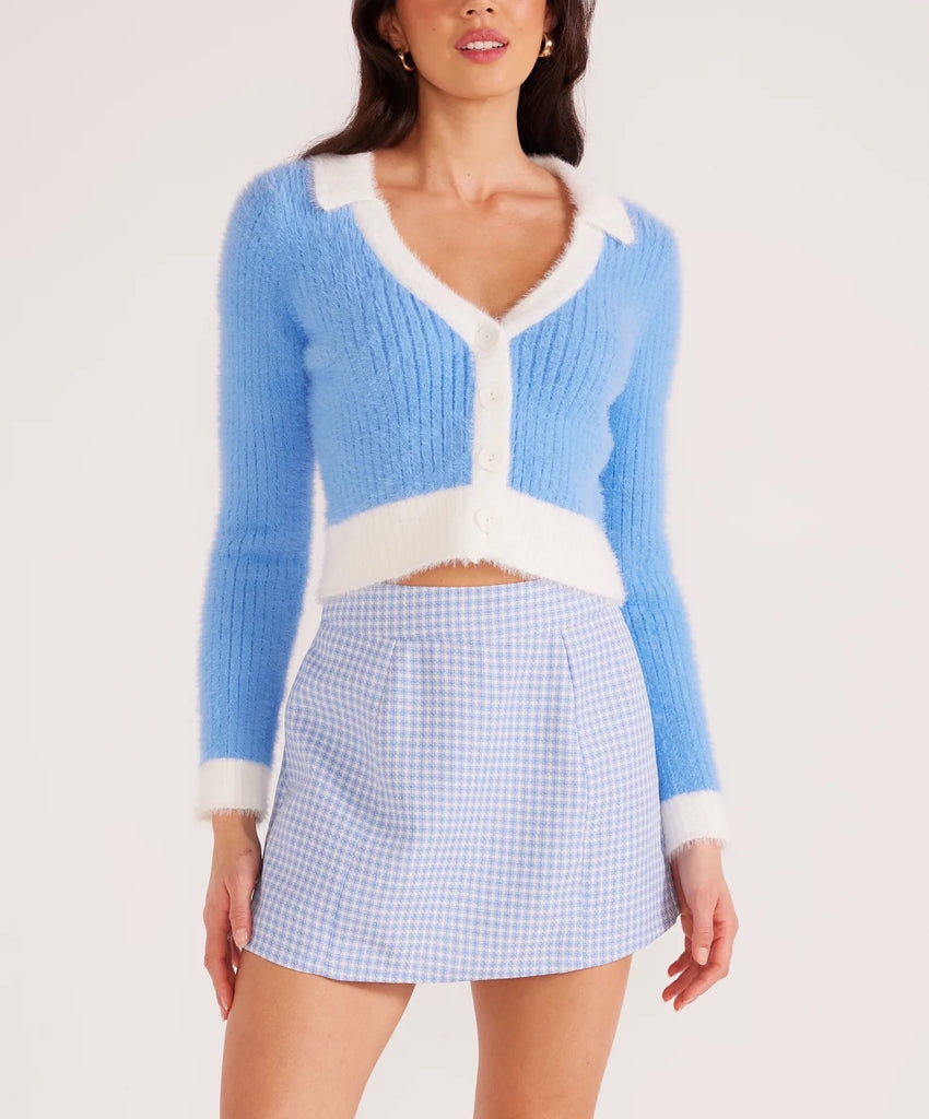 Addison Fluffy Knit Cardi Blue. This cozy knit cardigan features a cropped design and collared v-neckline with front button details, the perfect fun and preppy piece to add to your closet.