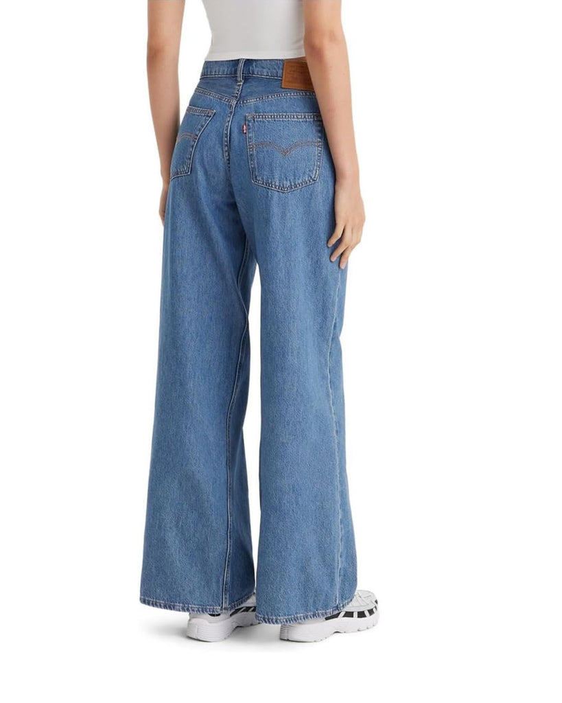 Levi Baggy Dad Wide Leg Cause and Effect. Designed with a mid-rise waist and a straight-leg style, these jeans are the ultimate wardrobe staple. The roomy and slouchy fit through the hip and thigh offers a relaxed feel, while the loose fit and wide-leg silhouette exudes a laid-back vibe.