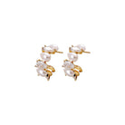 Stud earrings featuring freshwater pearls and pear-cut crystals in an elegant clustered design.
