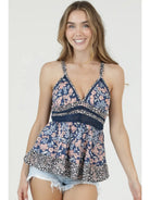 Floral printed camisole top with v-neckline, thin straps, and flowy fit styled with denim shorts