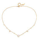Dainty gold-tone chain necklace featuring bezel-set round and pear-shaped crystal accents spaced throughout the chain with an adjustable clasp.