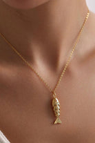 Dainty necklace featuring a detailed fish pendant suspended from a delicate chain.