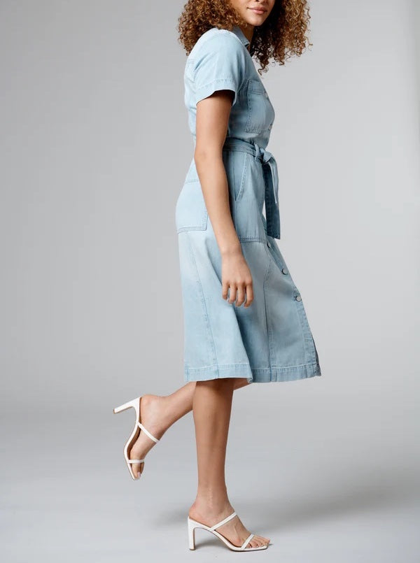 Blank NYC Guest List Dress Light Indigo. This belted short sleeve denim midi dress features a button down front with patch pockets for a country chic look perfect for the warmer months.