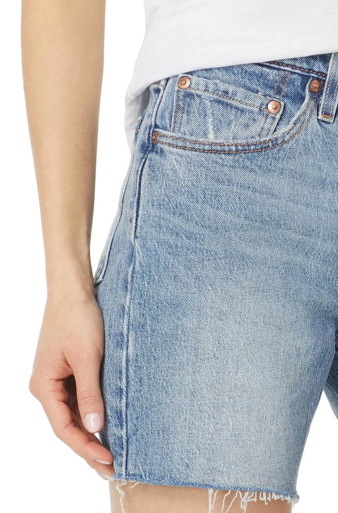 Levi Mid Thigh Short Odeon. Raw hems and strategic whiskering add to the vintage vibe of these slightly stretchy denim shorts that hit at the mid thigh for a look that's comfy and classic.