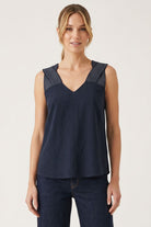 Sleeveless V-neck top with contrast stitched shoulder detailing and relaxed fit.