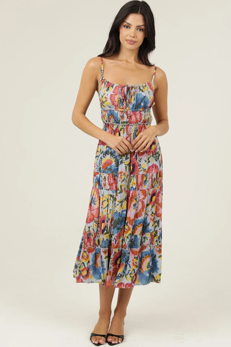 Printed midi dress with thin straps, smocked bodice, and tiered skirt styled with sandals