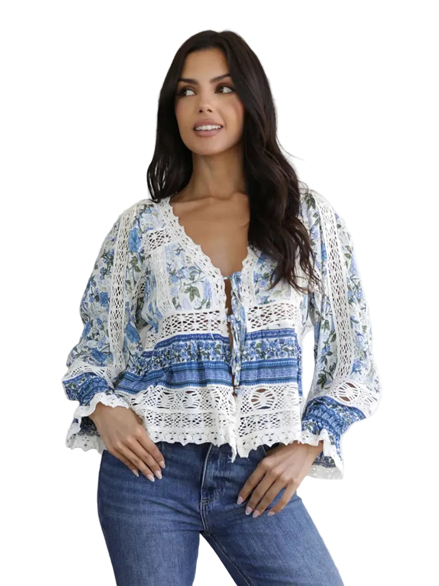 Women's floral print blouse with crochet lace detailing, long puff sleeves, tie-front neckline, and a relaxed bohemian silhouette.