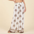 Palm print wide leg pants with elastic waistband and drawstring detail styled for a resort look