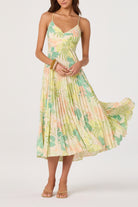 Pleated midi dress with open back, tie detail, and thin straps, shown from the back.