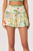 Model wearing a tropical print wrap-front skort with built-in shorts.
