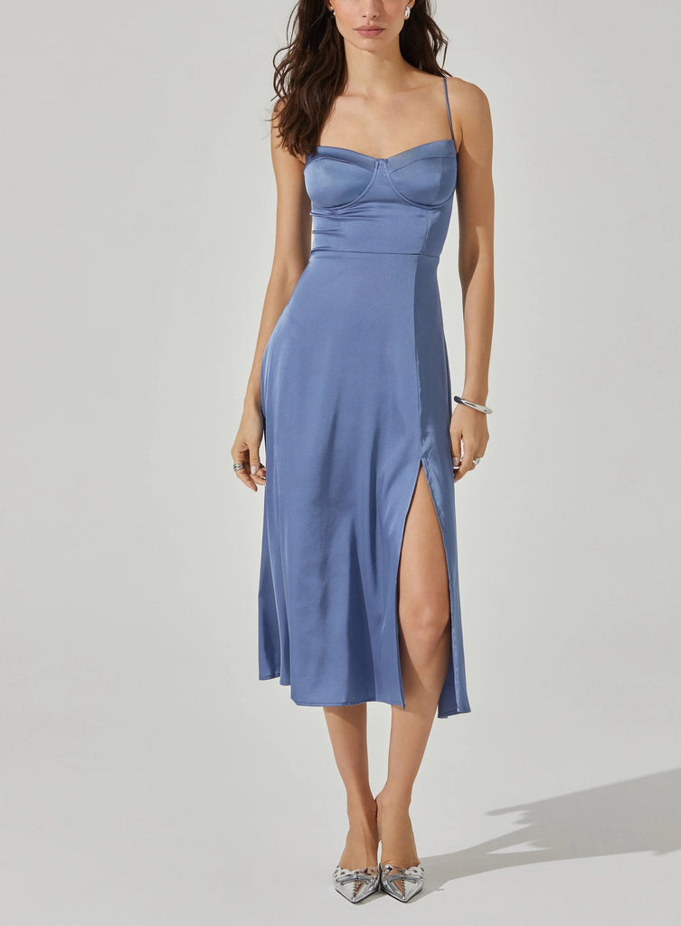 Astrid Bustier Satin Dress Slate Blue. This midi dress features a sweetheart neckline with a cupped bust and adjustable straps with a side slit accent and zipper closure at back, perfect any special event.