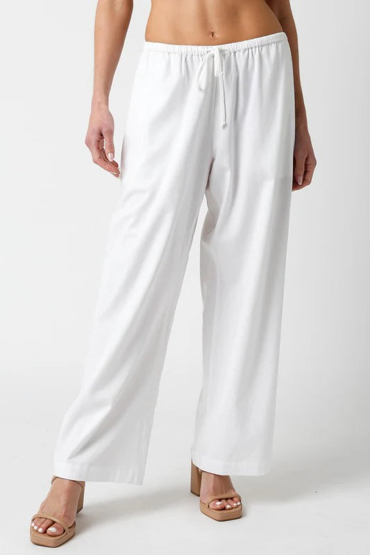 Brylee Wide Leg Flowy Pant White. These pants feature an elastic drawstring waist for a comfortable feel and a wide leg fit for an effortless boho chic look perfect for pairing with your fav fitted top.