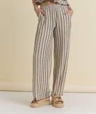 Textured striped wide leg pants with elastic waistband and relaxed fit styled with matching top and sandals