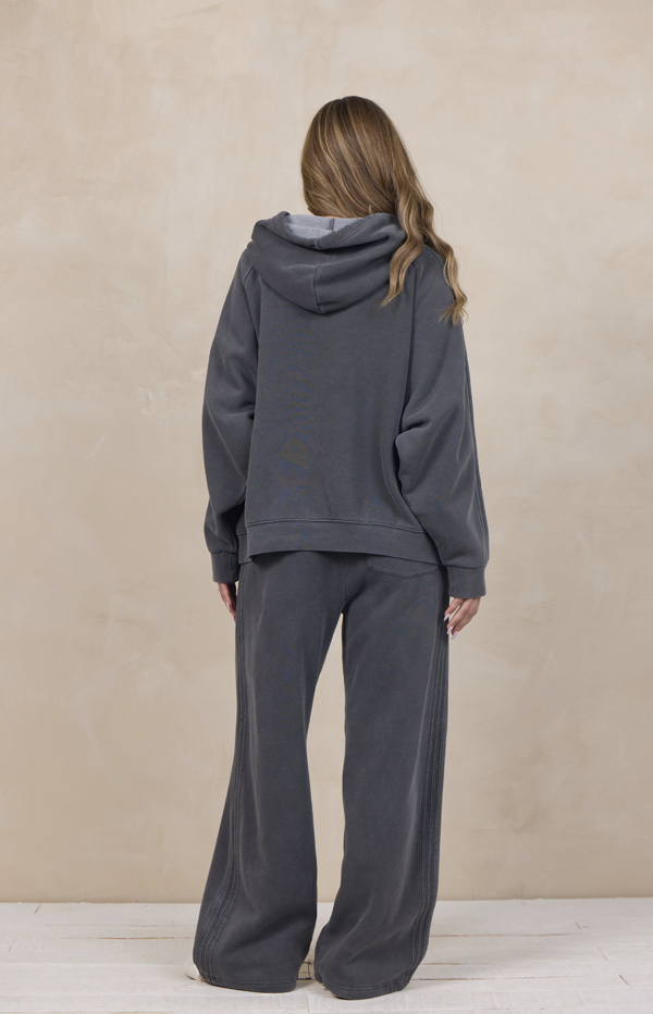 Woman wearing a wide-leg sweatpant with an elastic waist.