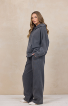 Woman wearing a wide-leg sweatpant with an elastic waist.