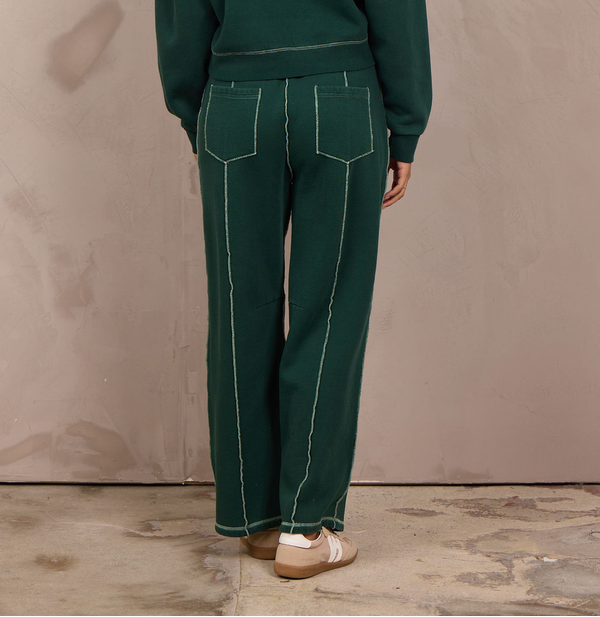 Woman wearing a wide-leg barbell pant with contrast stitching.