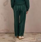 Woman wearing a wide-leg barbell pant with contrast stitching.