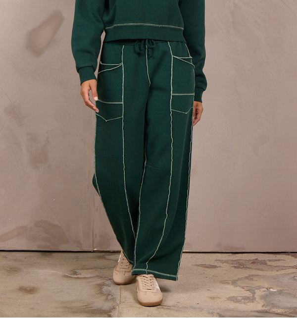 Woman wearing a wide-leg barbell pant with contrast stitching.