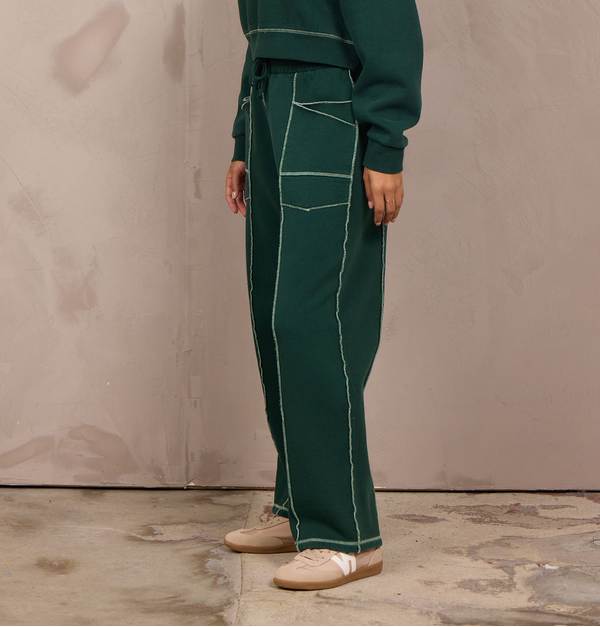 Woman wearing a wide-leg barbell pant with contrast stitching.