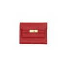 A red pebbled leather cardholder wallet with a gold-tone turn-lock clasp, shown flat against a solid white background.