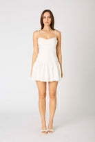 Mini dress with thin straps, fitted bodice, and flared skirt