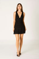 black mini dress, little black dress, ruched dress, cocktail dress, date night outfit, flirty mini dress, holiday party dress, going out outfit, classic black dress, polka dot dress, sheer overlay dress, open back dress, v-neck mini, women’s evening dress, elegant black dress, trendy mini dress, timeless LBD, modern party dress