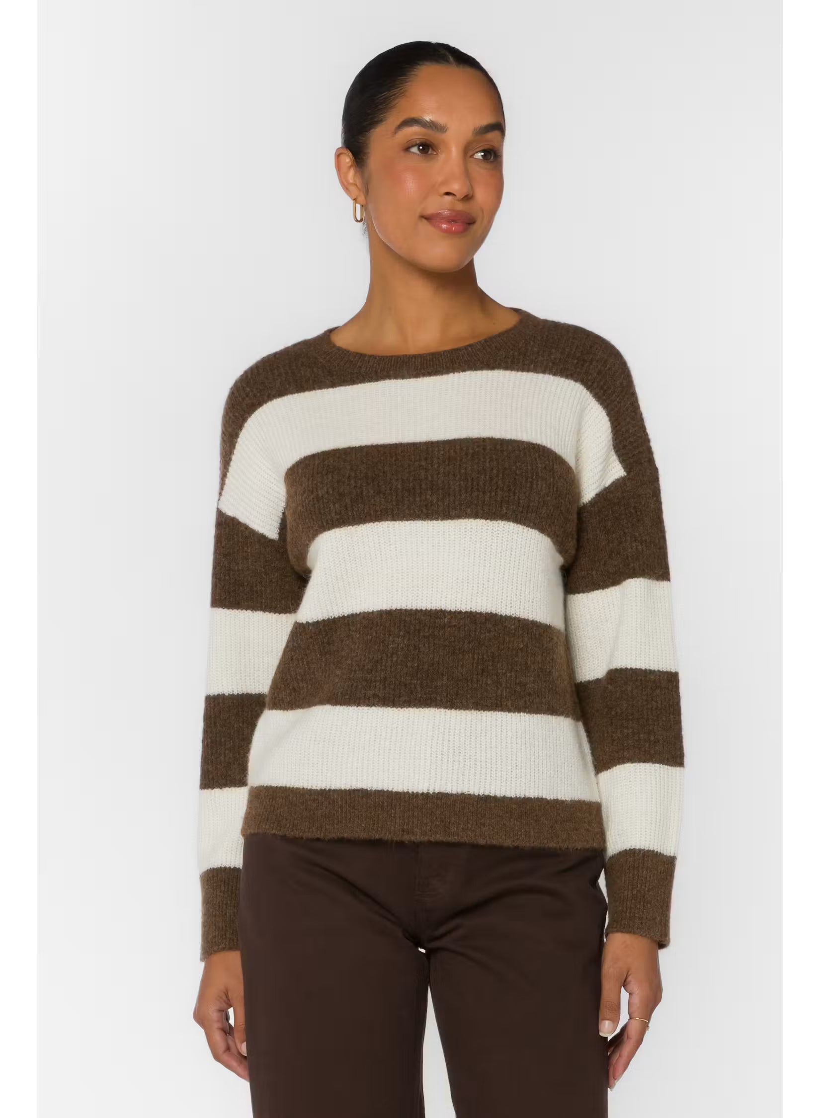 woman wearing a brown and white striped crew neck relaxed fit sweater