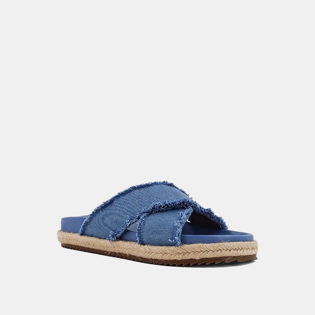 Courtney Sandal Denim. Upgrade your summer wardrobe with these slip-on sandals. Experience unparalleled comfort with its molded footbed and enjoy the stylish blue distressed denim textile fabric complementing any casual outfit. The rope-detailed outsole adds a touch of sophistication to this chic and versatile sandal.