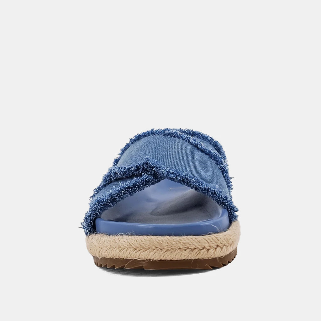 Courtney Sandal Denim. Upgrade your summer wardrobe with these slip-on sandals. Experience unparalleled comfort with its molded footbed and enjoy the stylish blue distressed denim textile fabric complementing any casual outfit. The rope-detailed outsole adds a touch of sophistication to this chic and versatile sandal