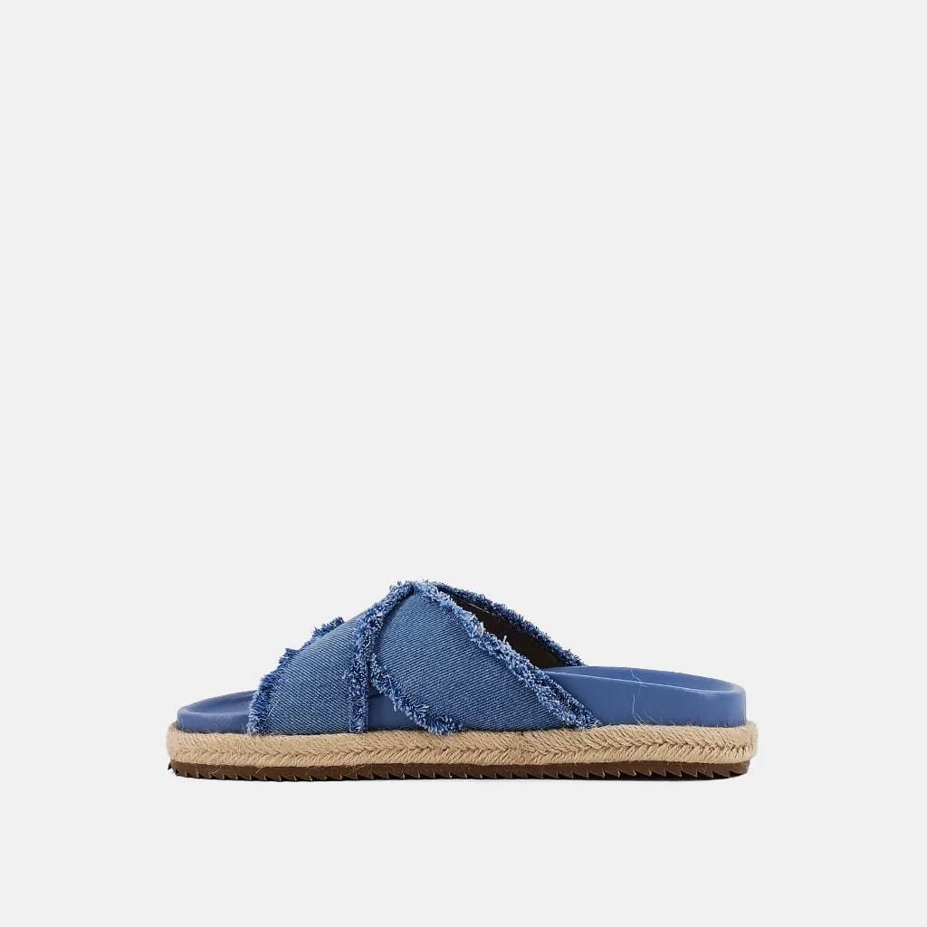 Courtney Sandal Denim. Upgrade your summer wardrobe with these slip-on sandals. Experience unparalleled comfort with its molded footbed and enjoy the stylish blue distressed denim textile fabric complementing any casual outfit. The rope-detailed outsole adds a touch of sophistication to this chic and versatile sandal.