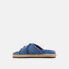 Courtney Sandal Denim. Upgrade your summer wardrobe with these slip-on sandals. Experience unparalleled comfort with its molded footbed and enjoy the stylish blue distressed denim textile fabric complementing any casual outfit. The rope-detailed outsole adds a touch of sophistication to this chic and versatile sandal.