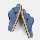 Courtney Sandal Denim. Upgrade your summer wardrobe with these slip-on sandals. Experience unparalleled comfort with its molded footbed and enjoy the stylish blue distressed denim textile fabric complementing any casual outfit. The rope-detailed outsole adds a touch of sophistication to this chic and versatile sandal.
