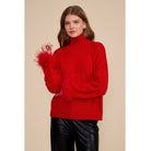 Red Clark Feather Trim Sweater with a ribbed mock neck, relaxed fit, dropped shoulders, and feather-trimmed cuffs